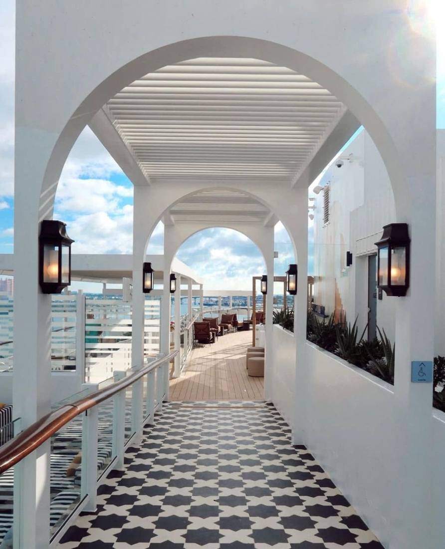 White arches over a black and white tiled walkway on deck
