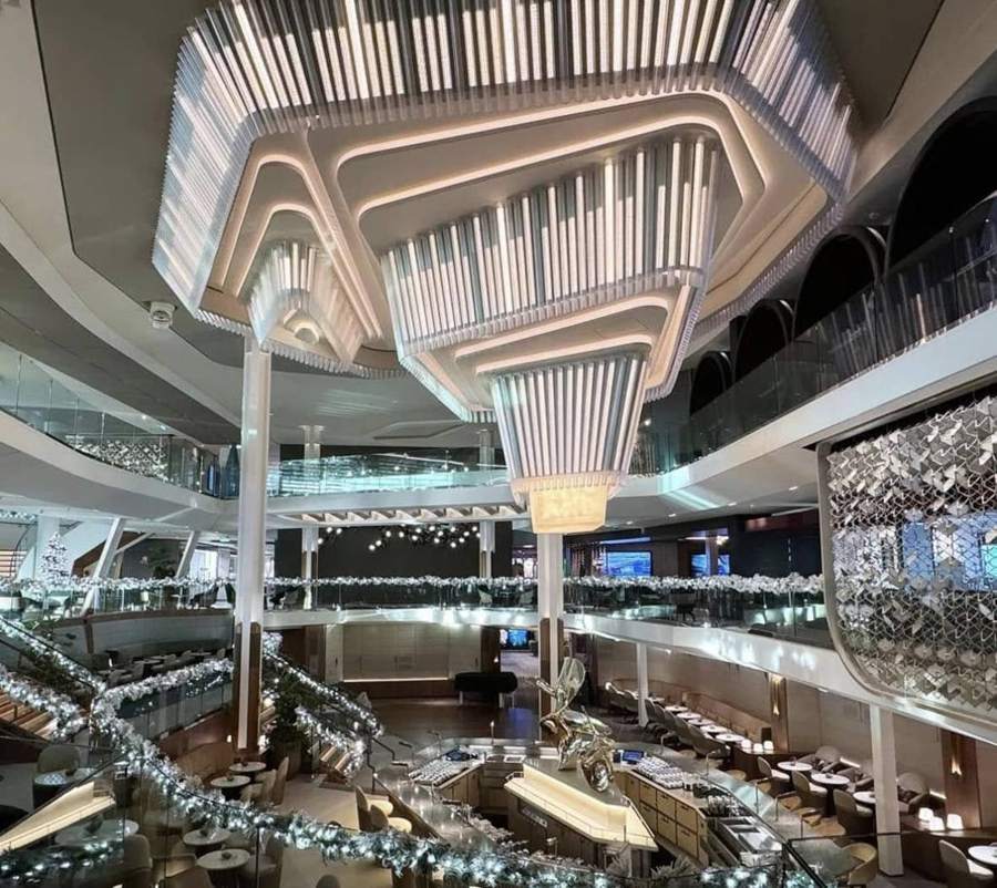 The multi-level atrium with a sculptural chandelier and holiday garland