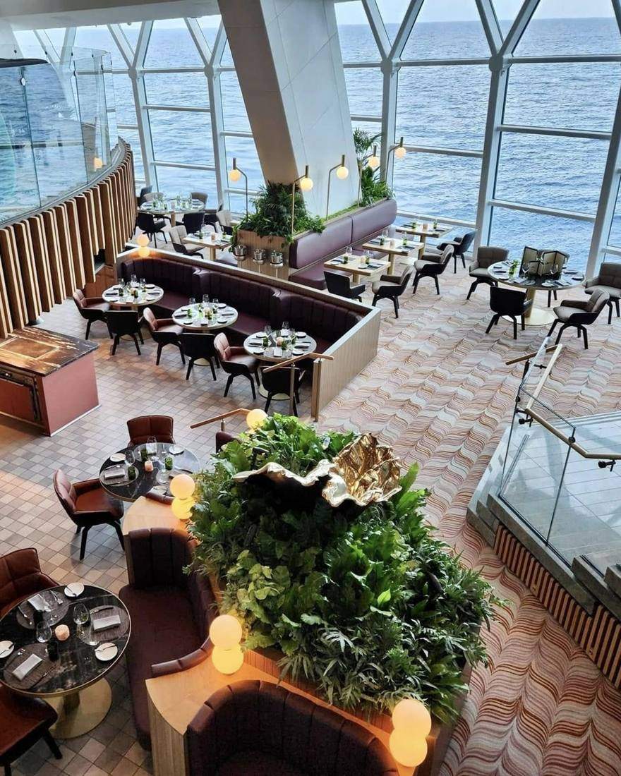 Looking down on a dining room with ocean-view windows