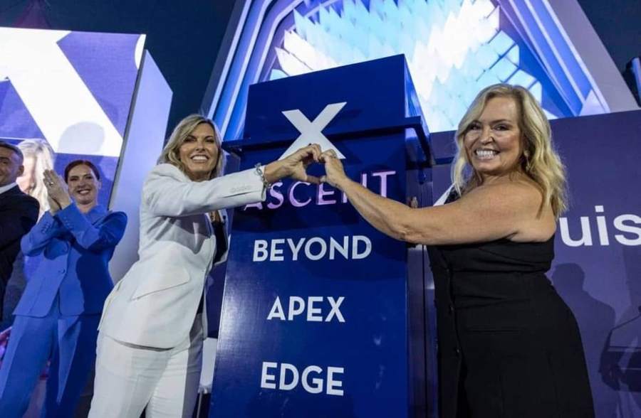 Naming ceremony stage with the ship name and class names on a blue pylon