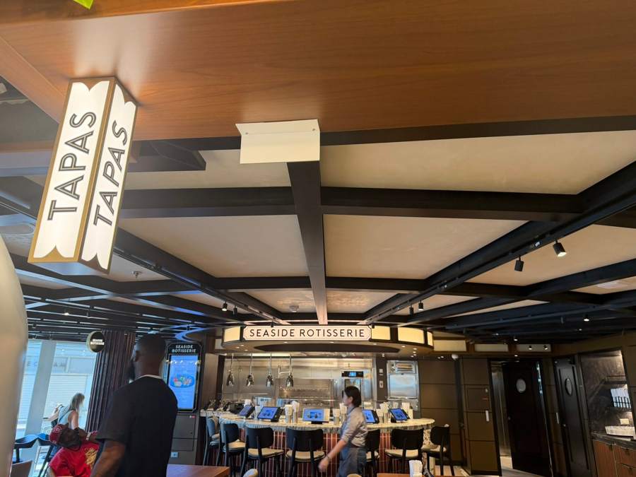 Hanging Tapas sign with the Seaside Rotisserie counter behind it